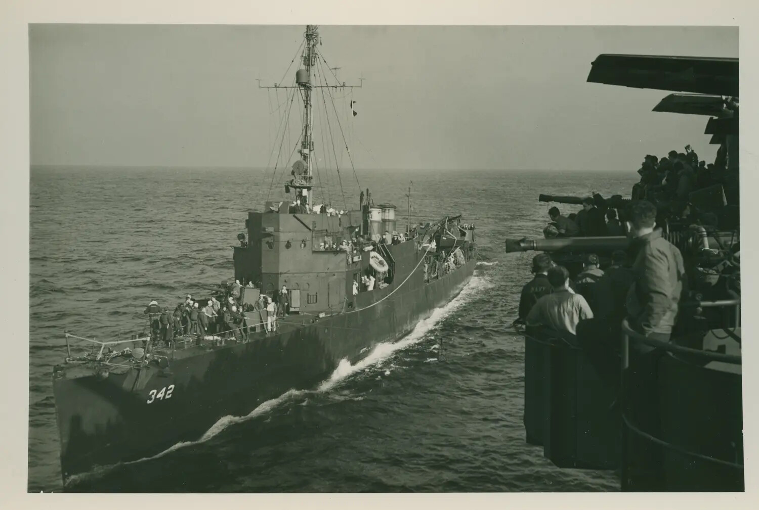 USS Petrof Bay (CVE-80) Alongside Escort Vessel Hull No. 342, Underway in the Pacific, WWII
