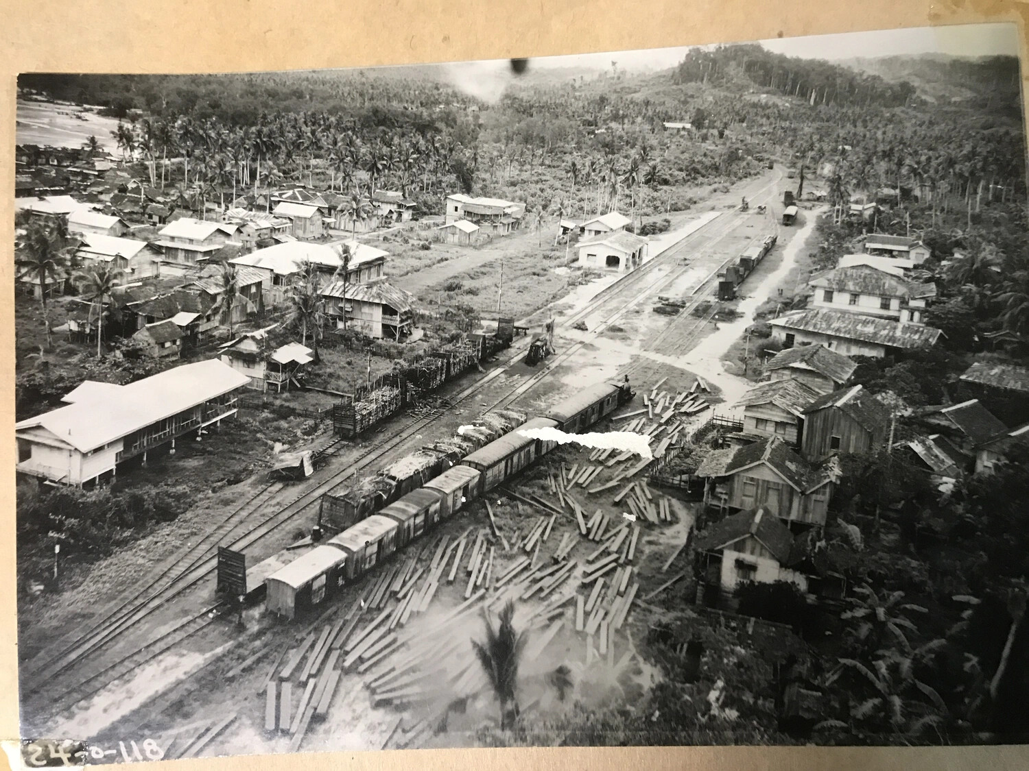 Aerial View of Rail Yard with Boxcars and Lumber Stockpiles (Full Print), Philippine Rail Town