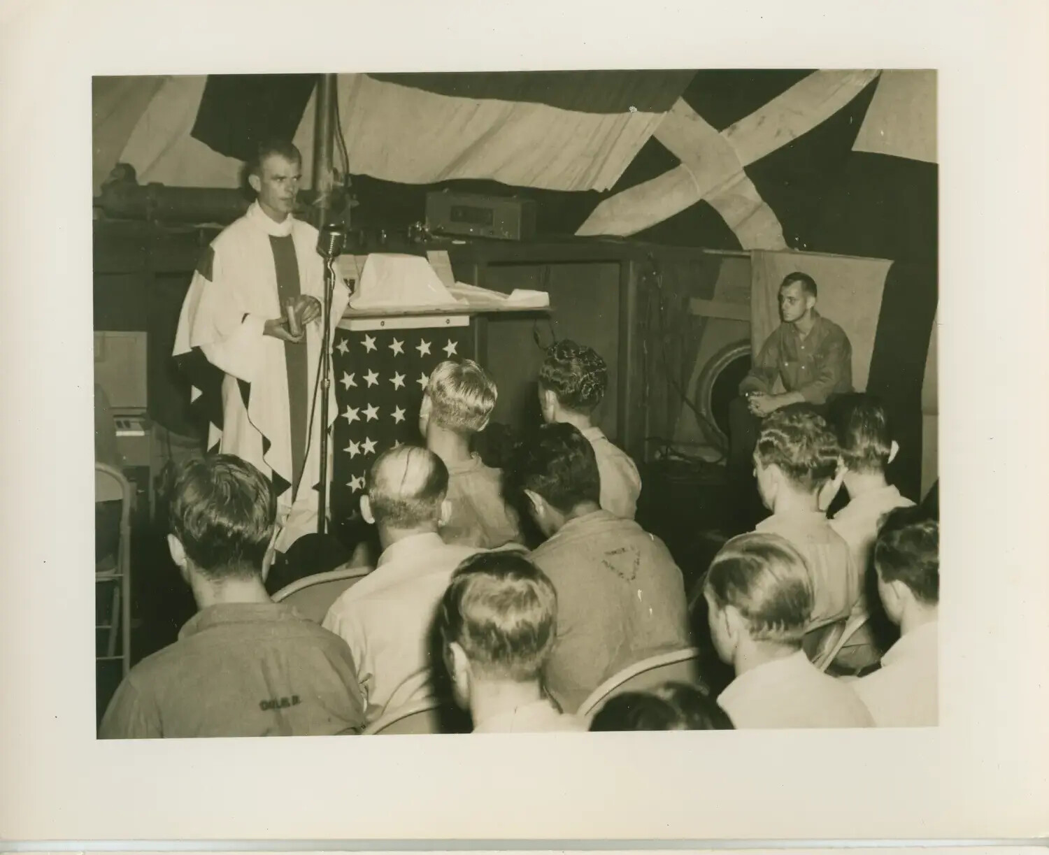 Chaplain Conducting Religious Service Aboard USS Petrof Bay (CVE-80)