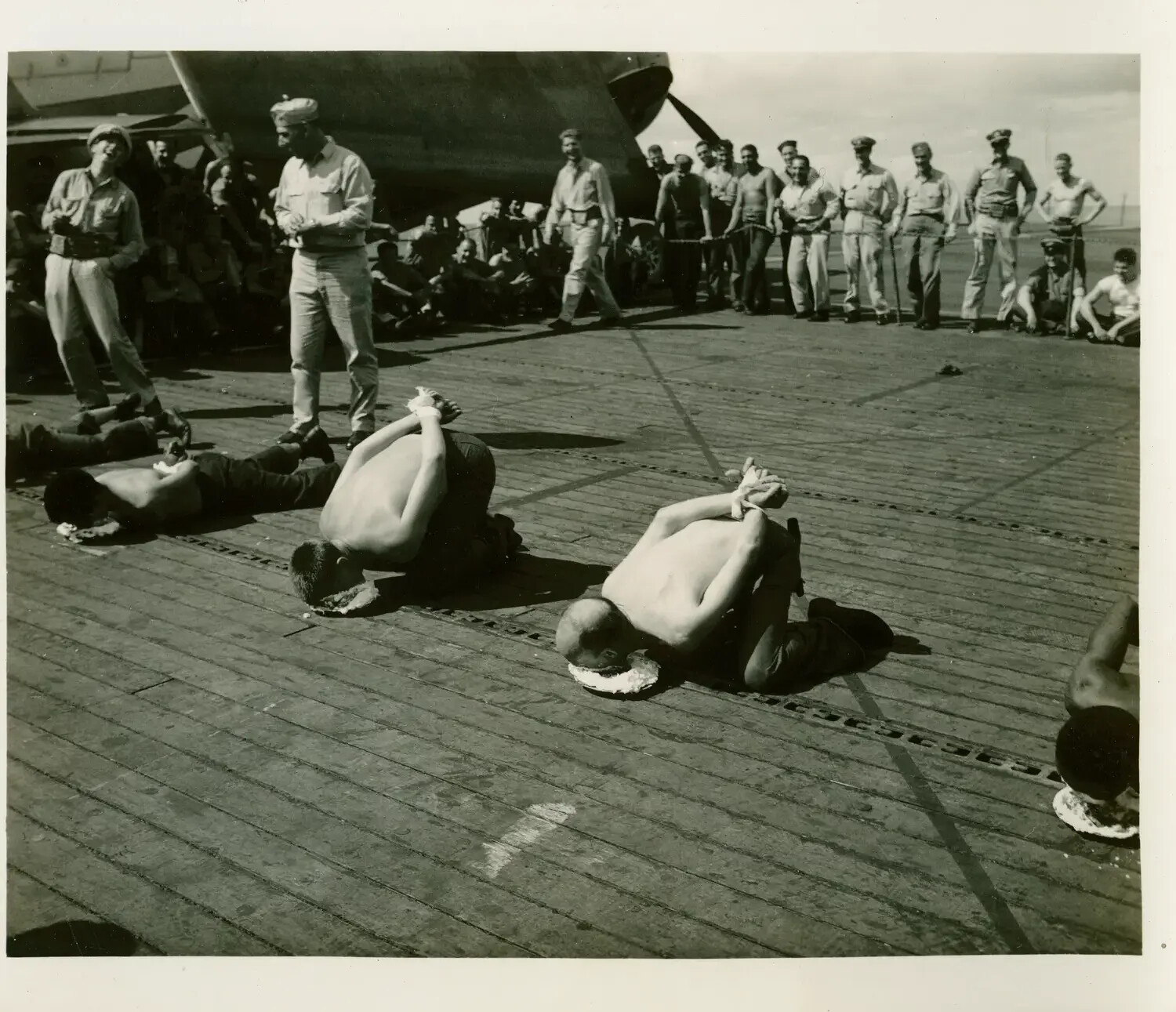 Hands-Free Pie-Eating Contest on Flight Deck, USS Petrof Bay (CVE-80)