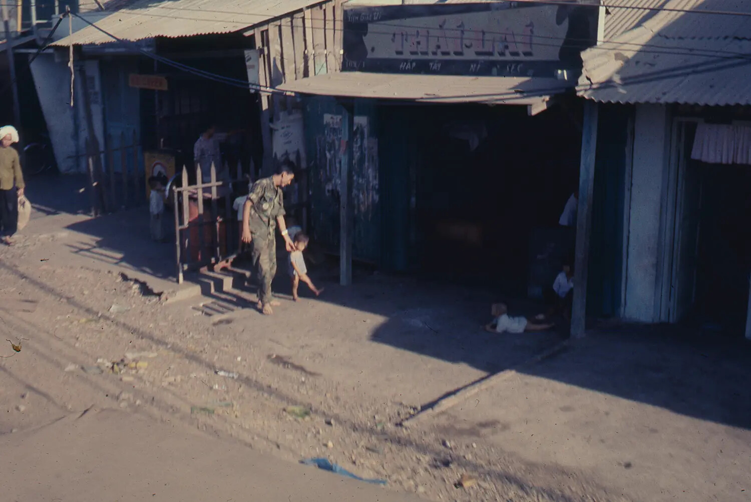 American Serviceman Walking with Vietnamese Child During Tet Offensive, 1968