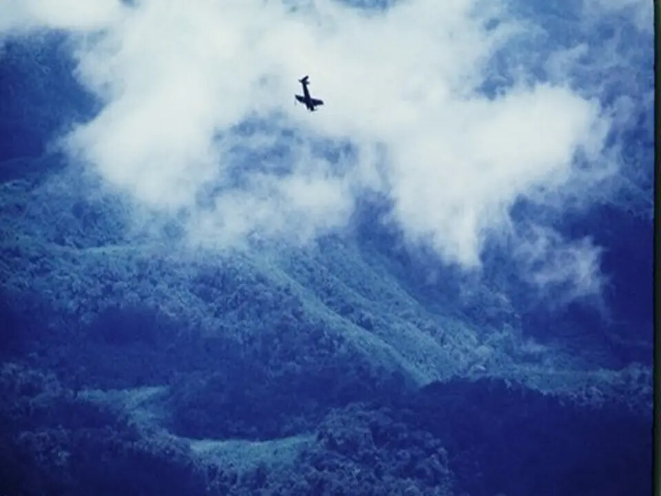 Air-to-Air View of Single-Engine Attack Aircraft Over Southeast Asian Jungle Terrain