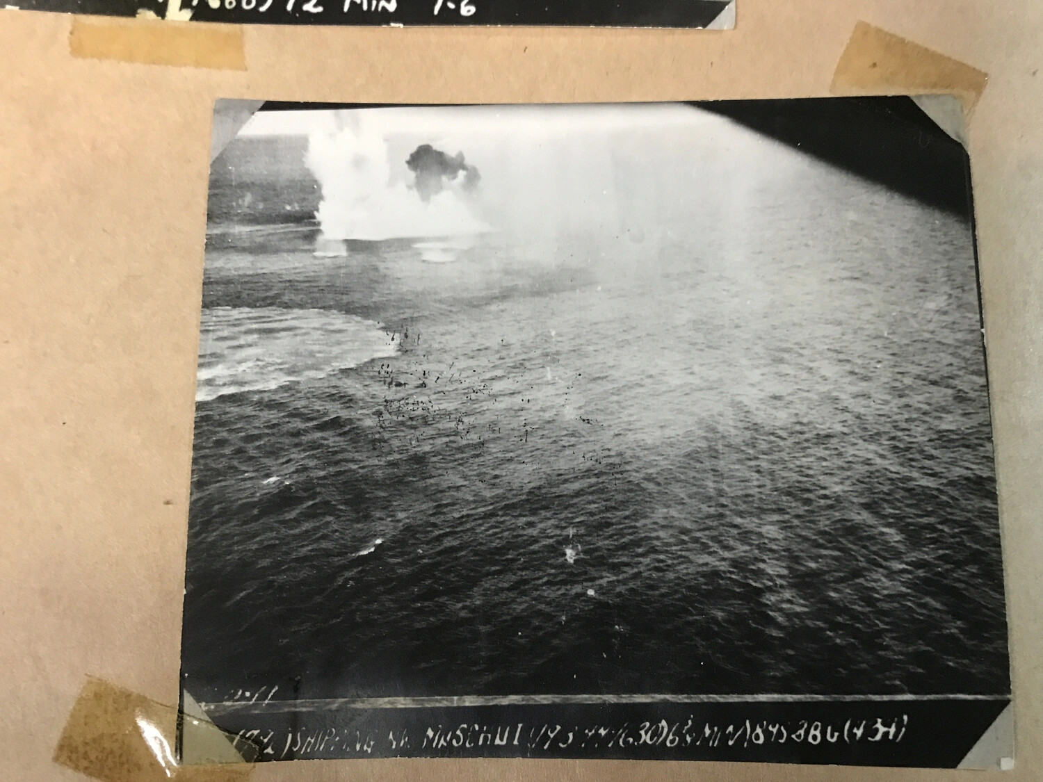 Bomb Burst Near Coastline with Original Caption Strip, Southwest Pacific