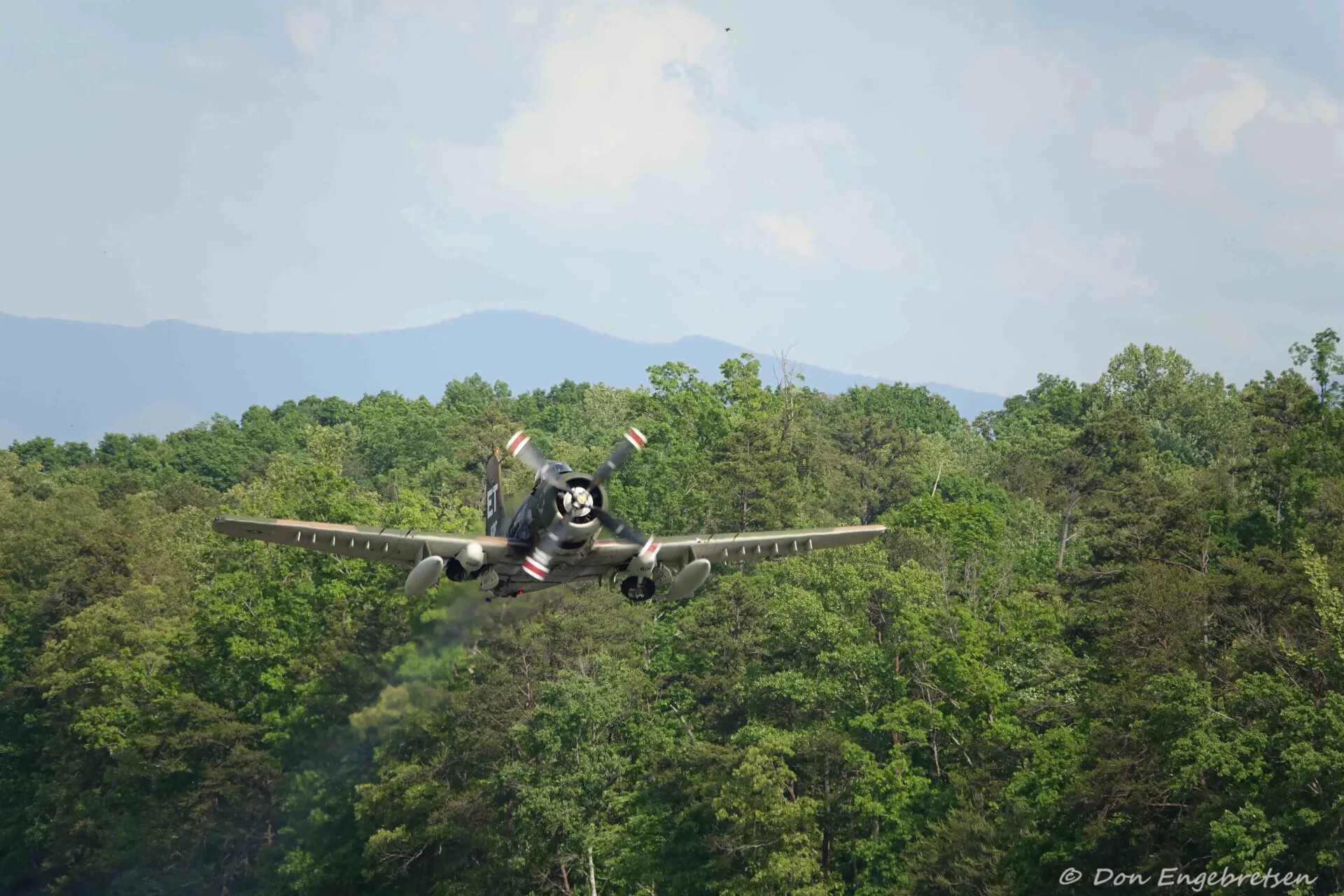 Douglas A-1 Skyraider 'ET' in Low Flight Over Forested Hills, May 2019
