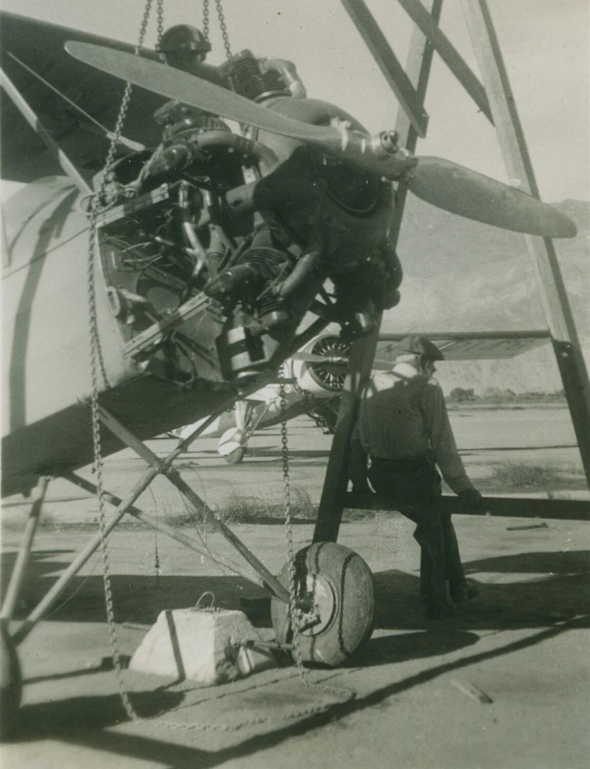 Ground Crew Performing Engine Removal/Maintenance on a Radial-Engine Trainer Aircraft