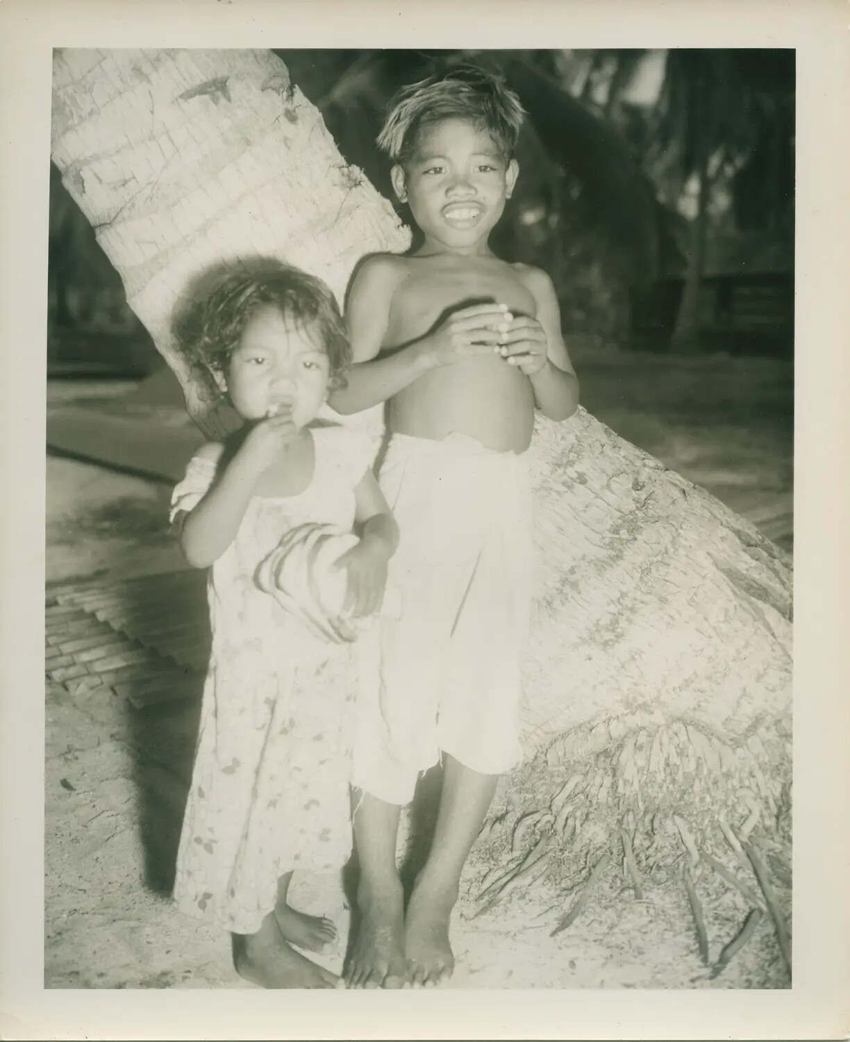 Portrait of Two Pacific Islander Children Beside a Coconut Palm, Petrof Bay Collection