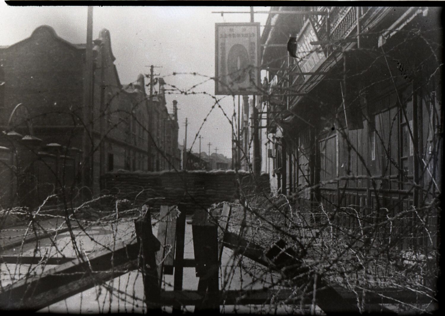 Barbed-Wire Street Barricade in a Chinese Commercial District, Wartime China