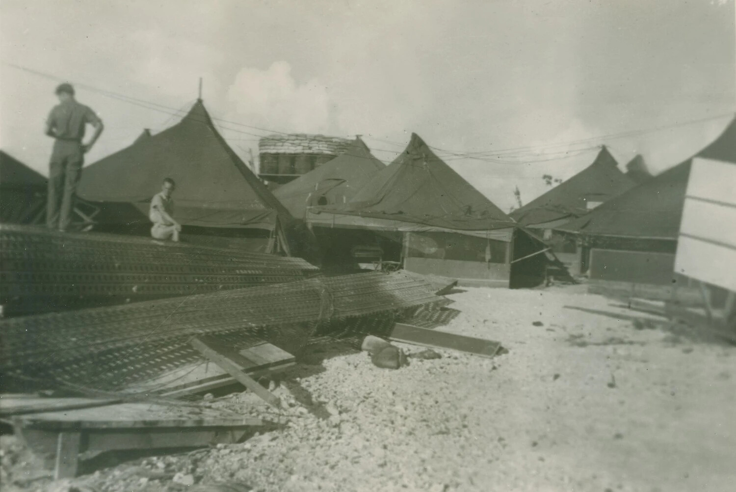 U.S. Servicemen with Pierced Steel Planking (PSP) at a Pacific Theater Tent Camp