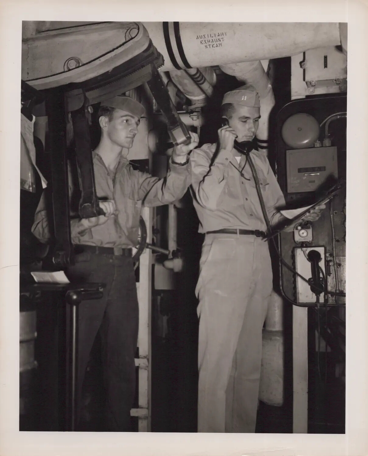 U.S. Navy Sailors on Engine Room Watch, Working Steam Valve and Ship's Telephone