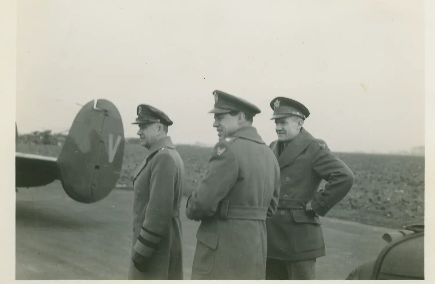 Three Officers Beside the Tail of a Twin-Engine Bomber, 579th Bomb Squadron Collection