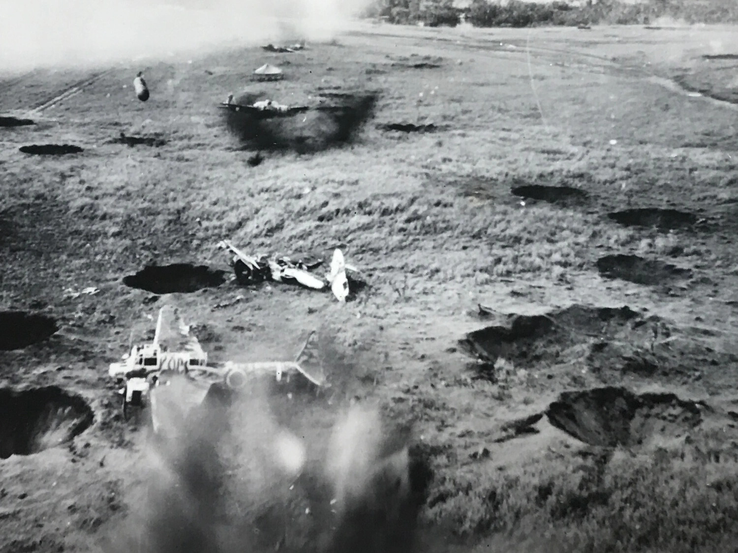 Low-Level Strike Photograph of Cratered Japanese Airfield Under Attack, Pacific Theater