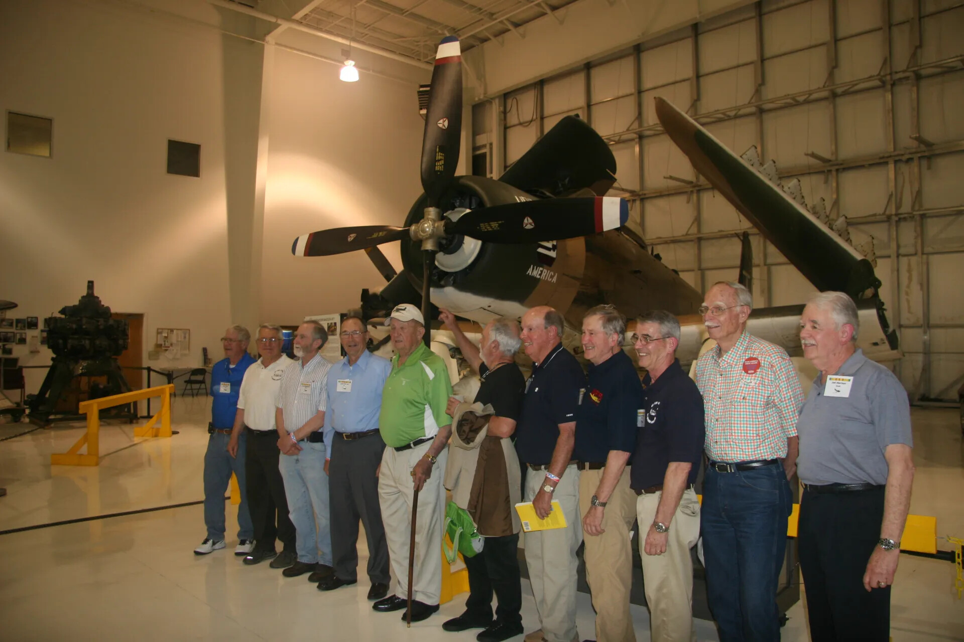 Eleven-Man Group Photo Beneath A-1 Skyraider 'AMERICA', Aviation Museum