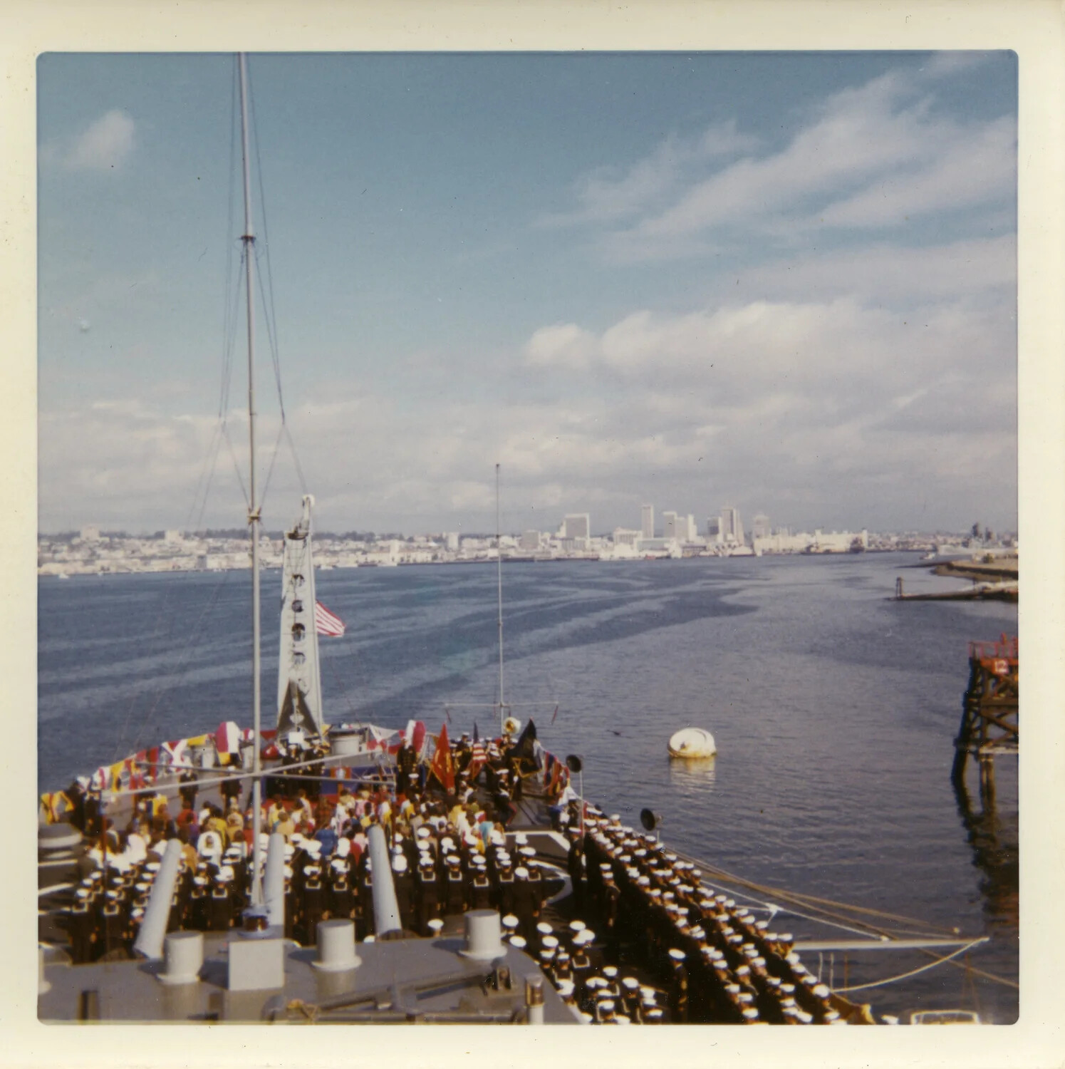 Dressed Ship with Crew Manning the Rail, USS Saint Paul (CA-73), San Diego Bay, circa 1970