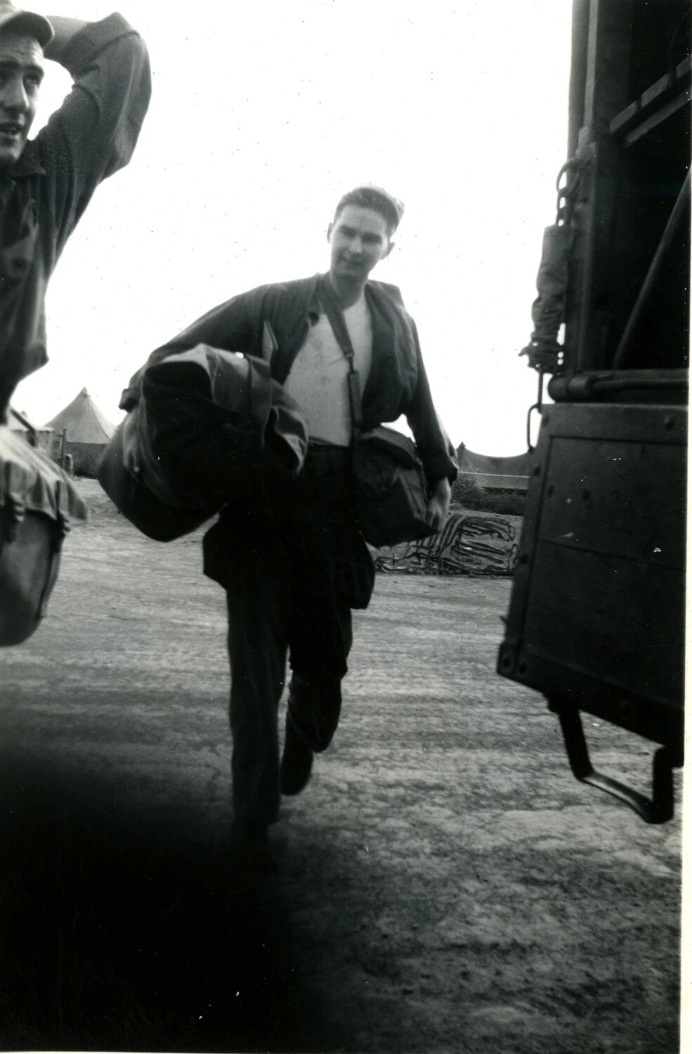 Marine Carrying Sea Bag and Gear Near Camp Vehicle, 5th Marine Division (Iwo Jima Campaign, 1945)