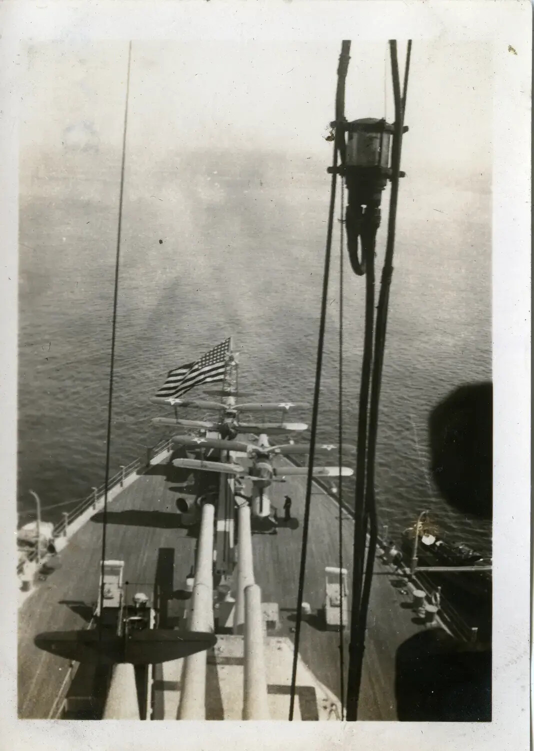 View Forward from the Foretop of USS Maryland (BB-46), Showing Main Battery Turrets and Scout Floatplane, 1930s