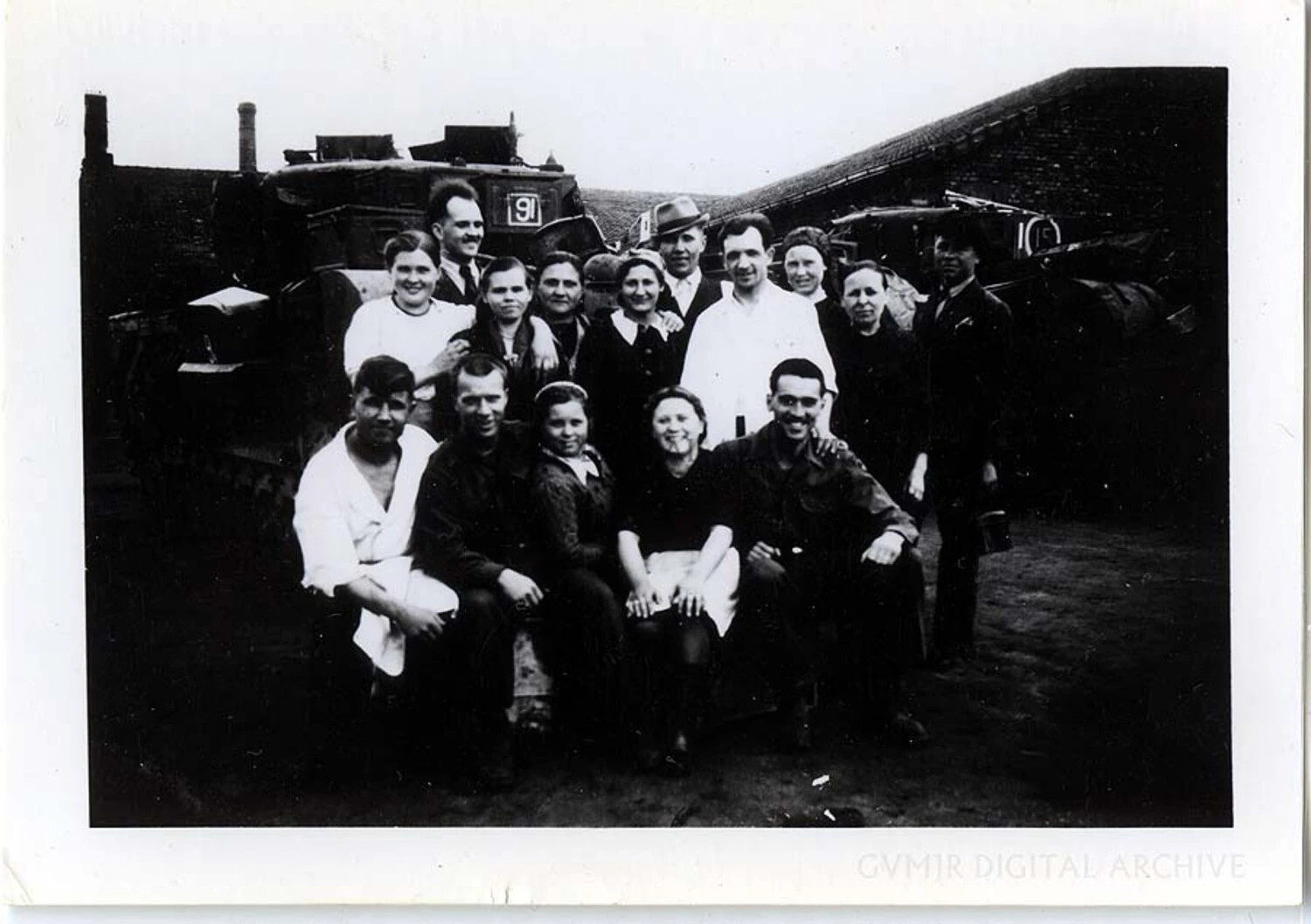 Group Portrait of Civilian Workers with Industrial Rail Locomotives, Germany, 1945