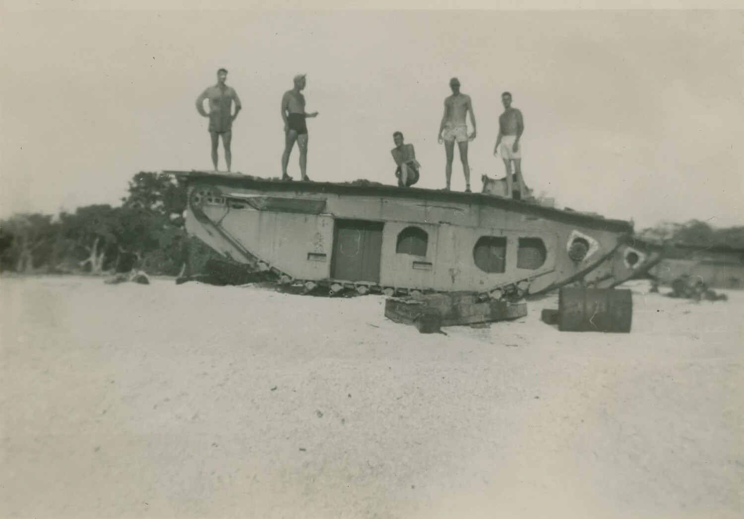 U.S. Servicemen Posing Atop a Derelict Amphibious Tracked Landing Vehicle (LVT) on a Pacific Beach, WWII