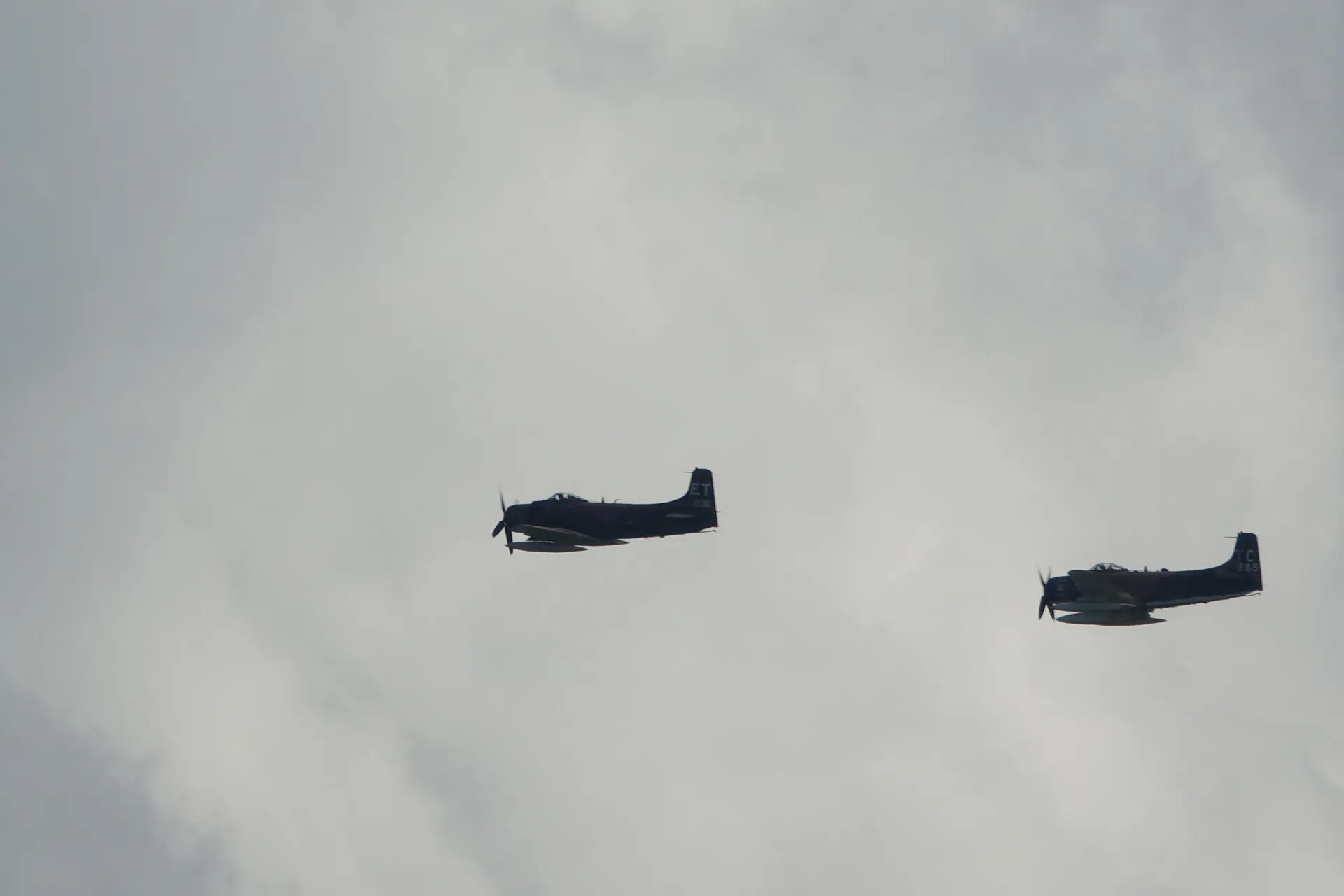 Two A-1 Skyraiders in Formation Flight, Overcast Sky
