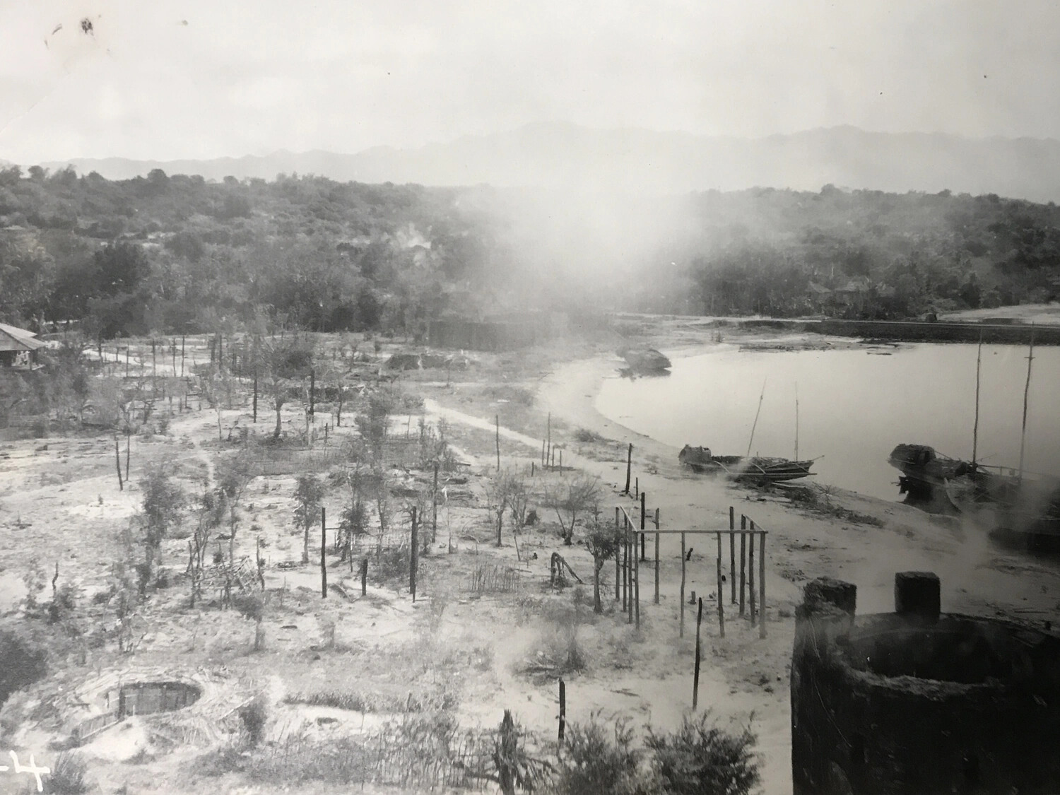 Post-Strike Photograph: Devastated Coastal Village with Skeletal Structures, Pacific Theater, WWII