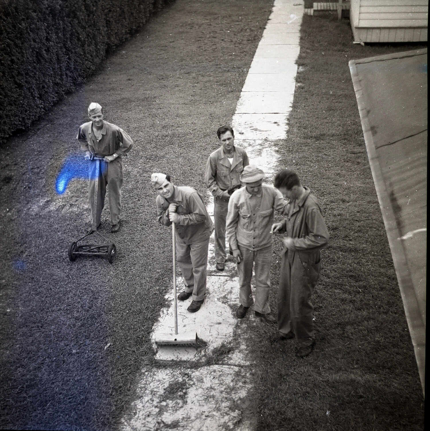 Servicemen Performing Grounds Maintenance Detail, Barracks Walkway
