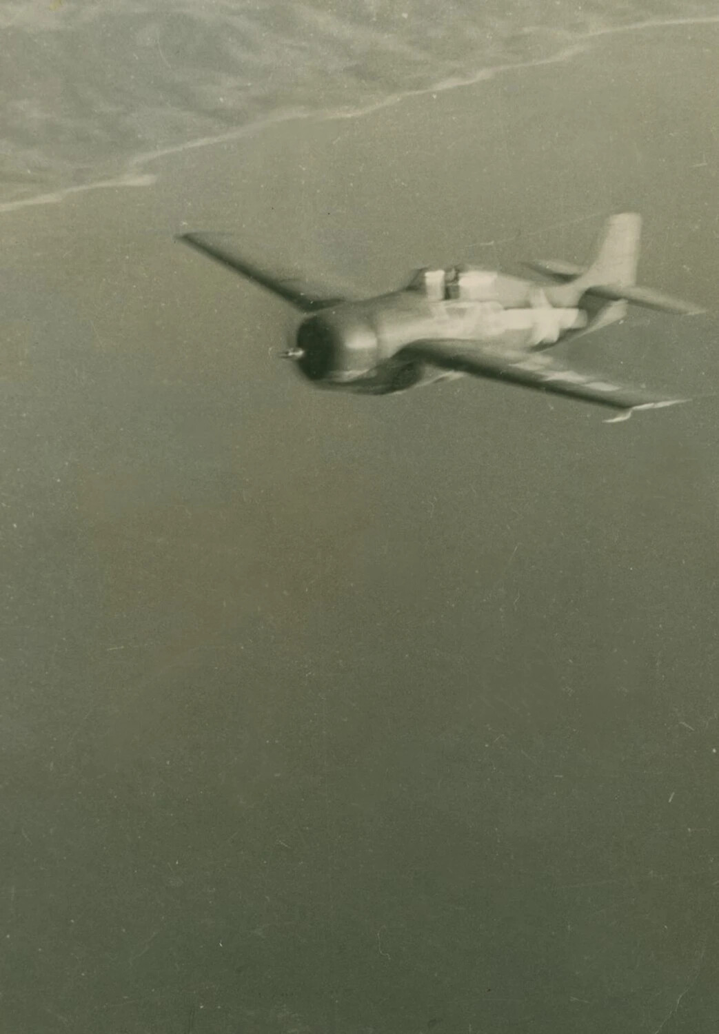 Air-to-Air Photograph of US Navy Fighter Over Coastal Waters, WWII