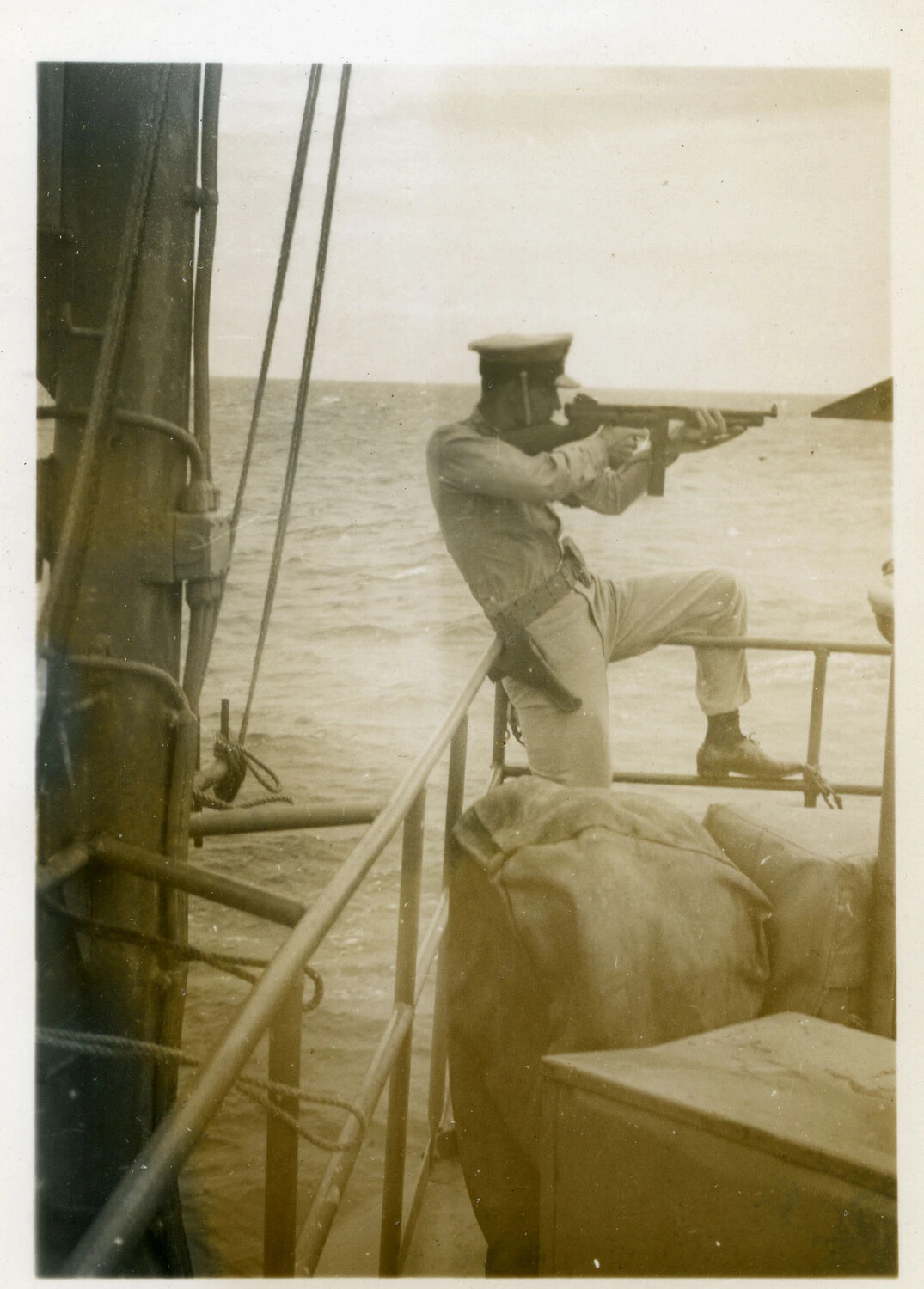 Sailor Firing a Thompson Submachine Gun from Shipboard, Pacific Theater, WWII
