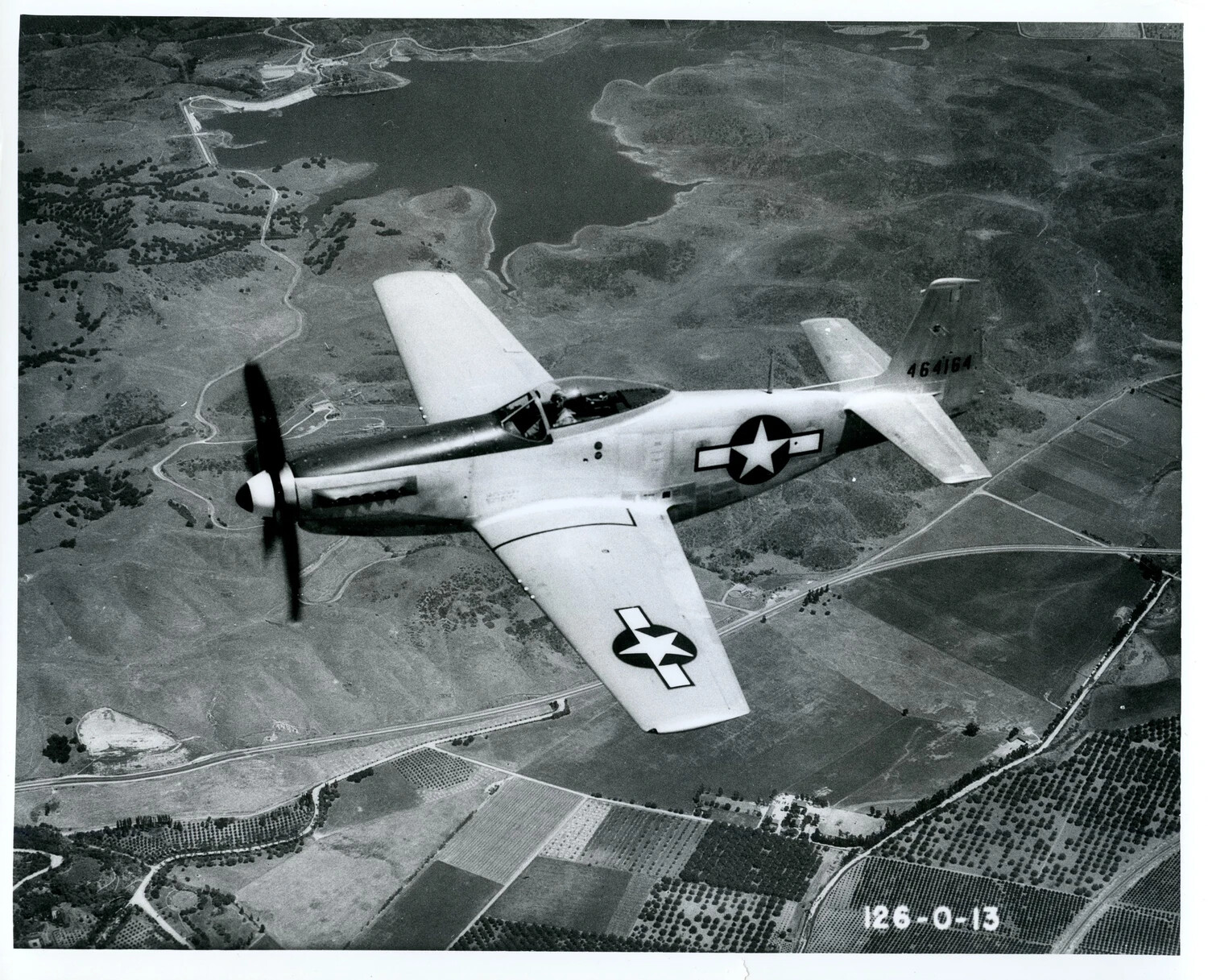 North American P-51 Mustang (P-51H) in Flight Over Farmland, Bare Metal Finish, Serial 464164
