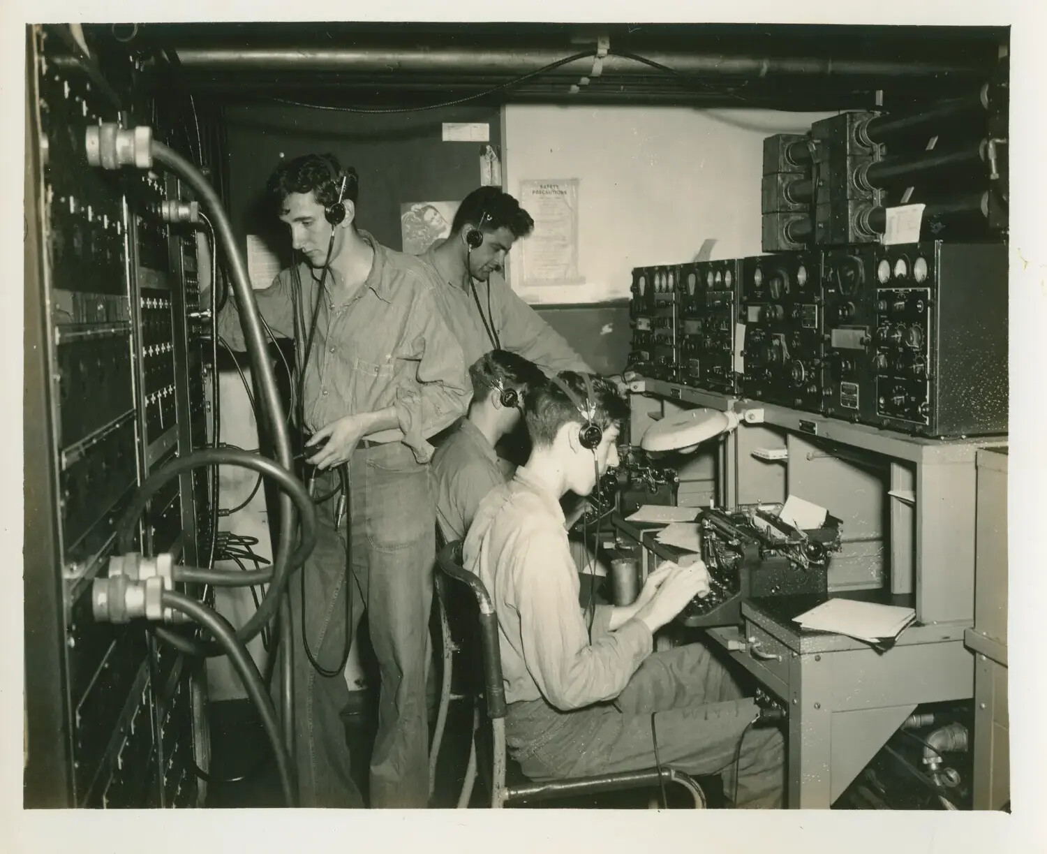 Radiomen at Work in the Communications Room, USS Petrof Bay (CVE-80)