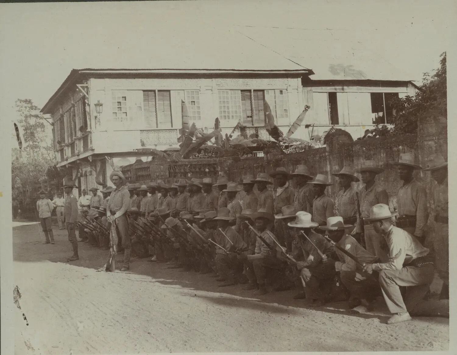Native Troops Drilling with Fixed Bayonets Before a Colonial Residence, Philippines, c. 1898-1901