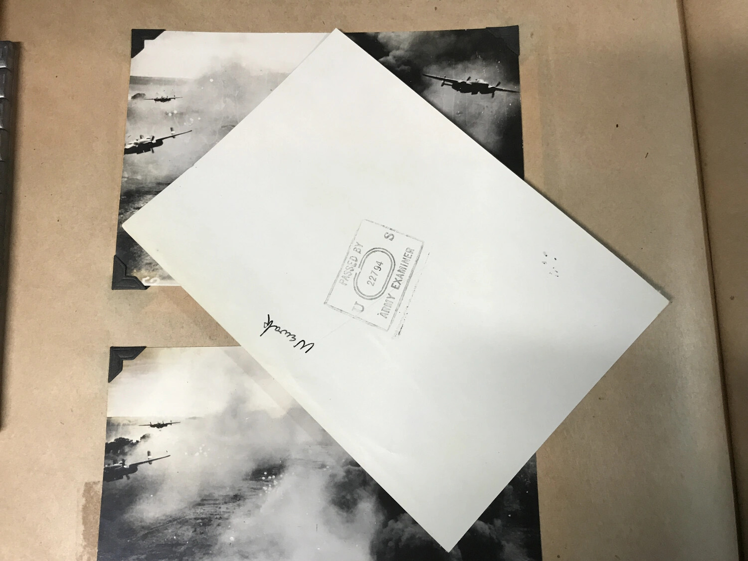 Censored Photo Envelope with 'Passed by U.S. Army Examiner' Stamp, Atop Combat Strike Prints