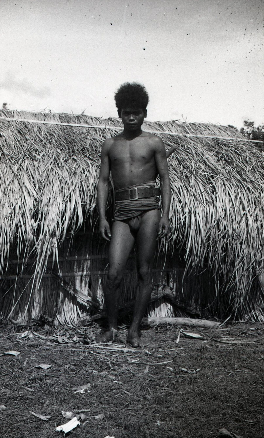 Portrait of a Young Man in Traditional Dress Before a Thatched Wall, Luzon, Philippines, World War II