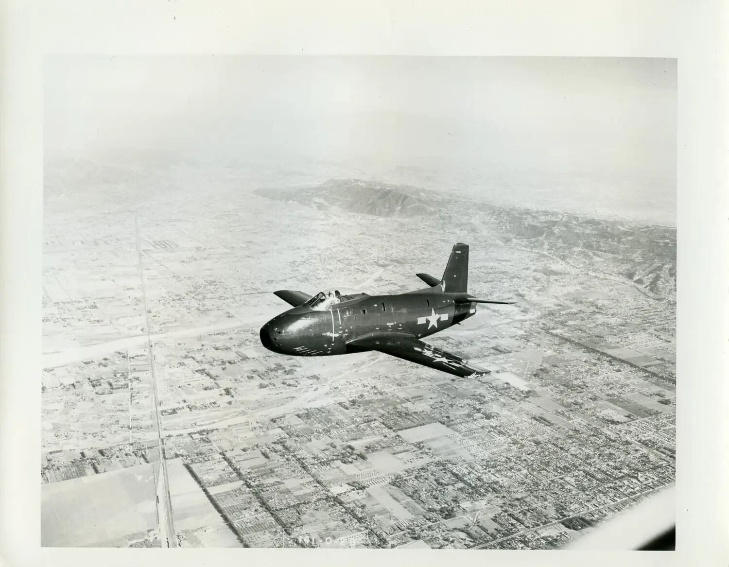 Early U.S. Navy Jet Fighter in Flight Over Los Angeles Basin, Late 1940s