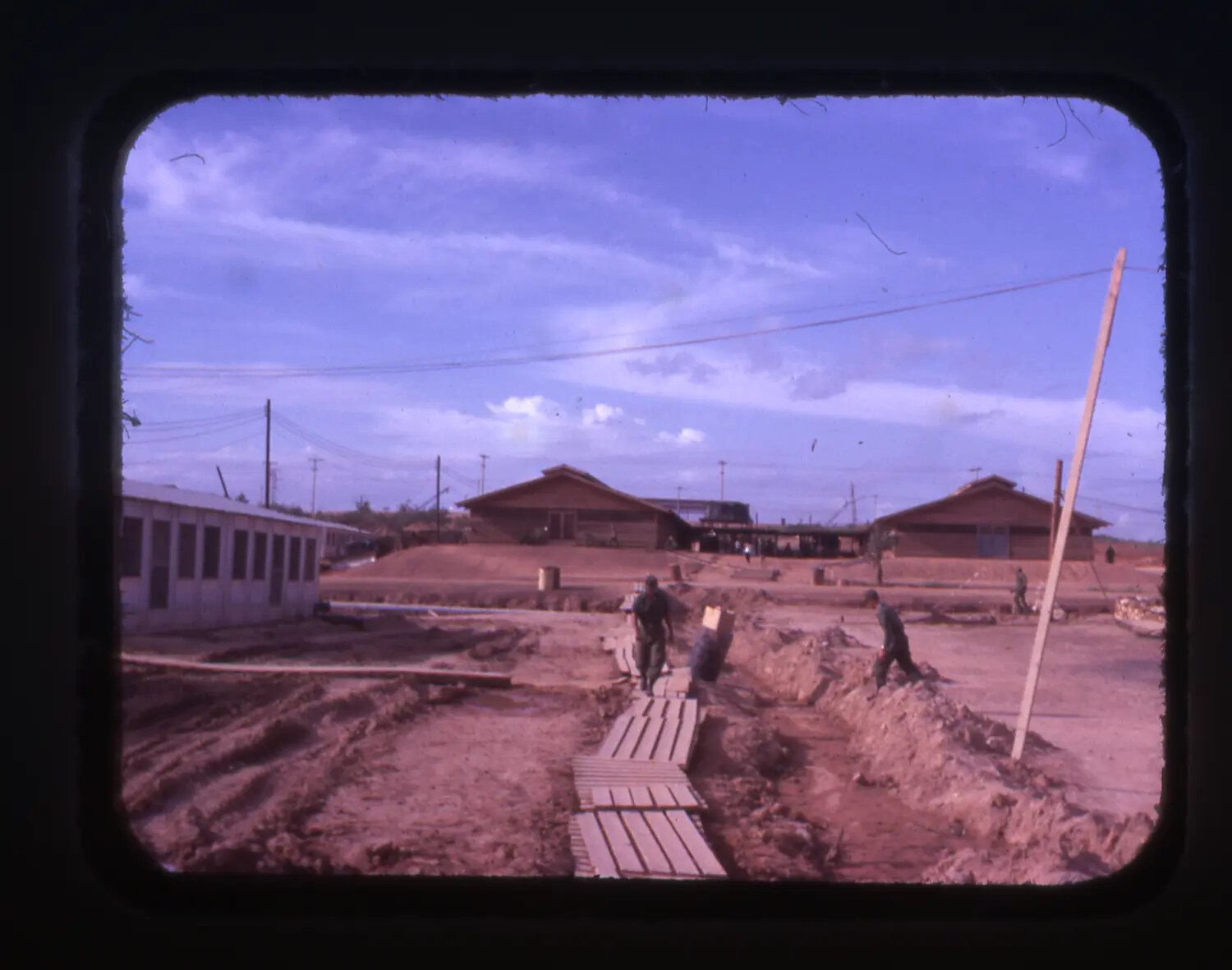 Vietnam War Era Color Slide: Soldiers Working in Muddy Construction Area, Base Camp, Vietnam