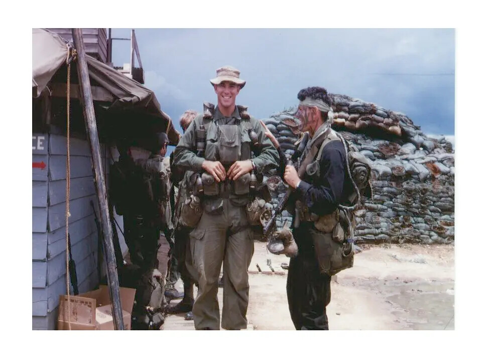 Two Personnel in Field Gear Beside Sandbagged Bunker, Vietnam War Era