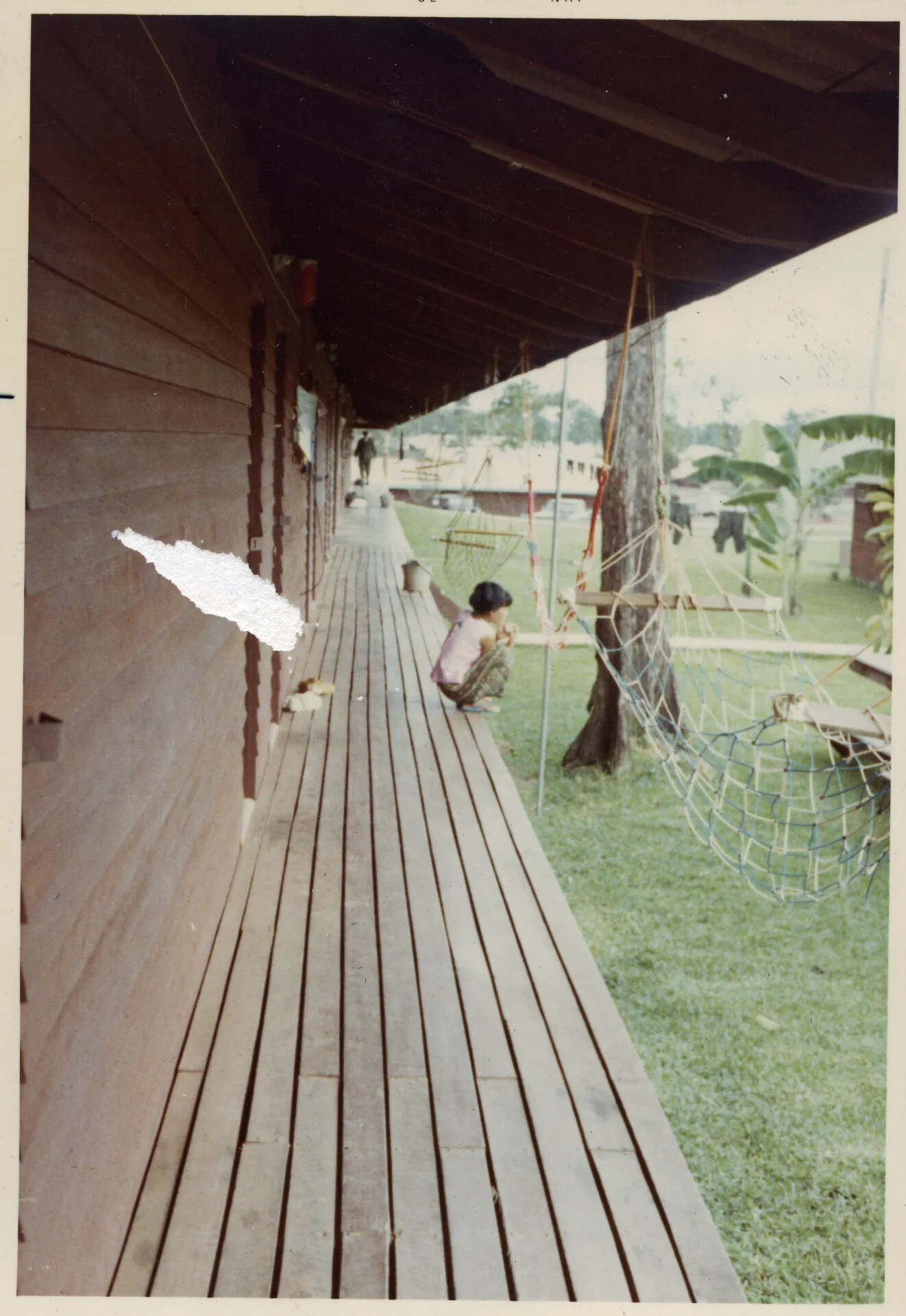 Covered Barracks Walkway with Local Domestic Worker, NKP, Thailand