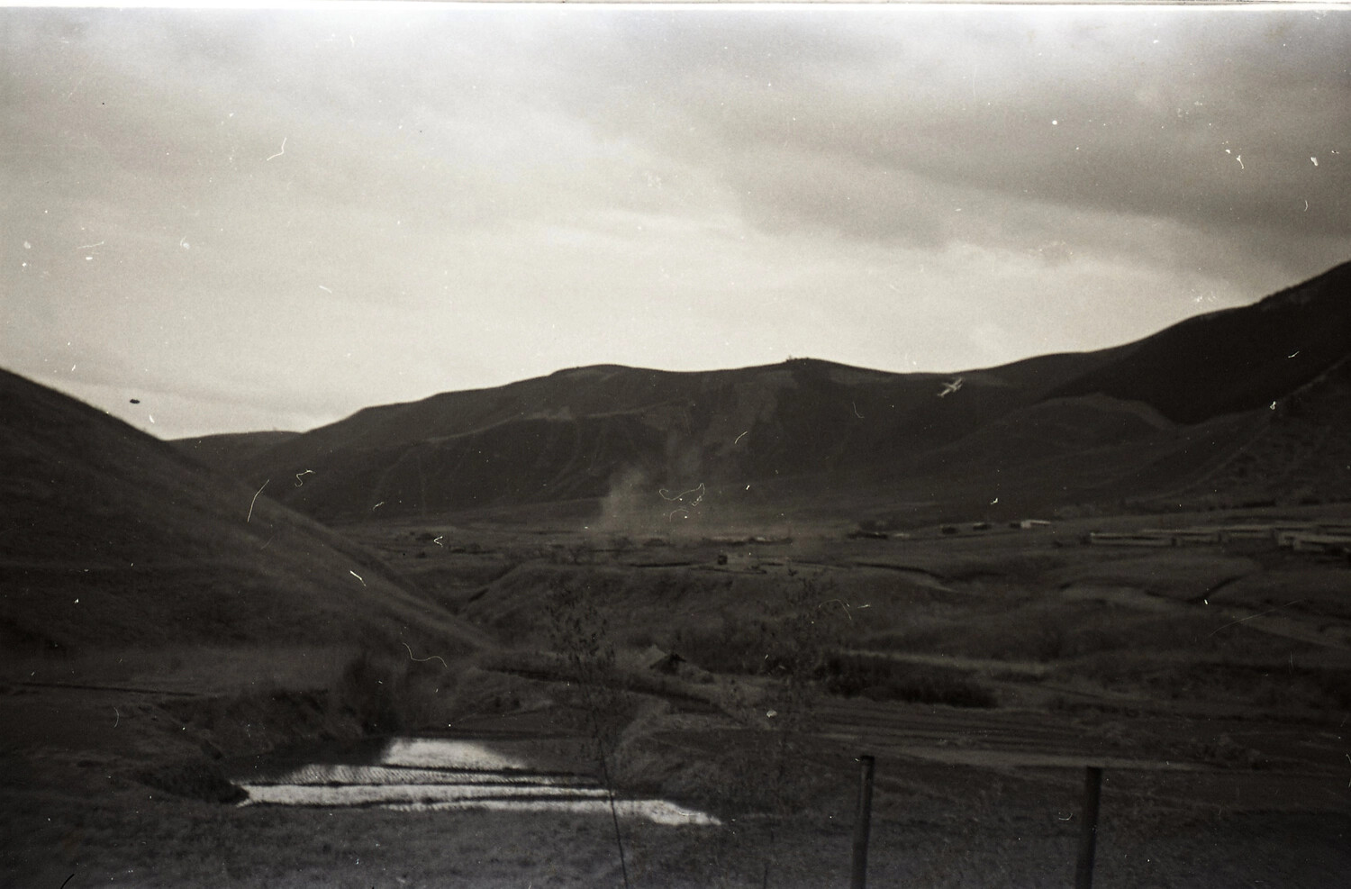 Valley Landscape with Rice Paddies and Distant Encampment, Korean War Era