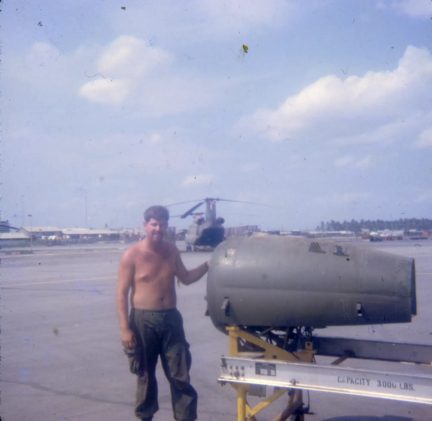 Airman Posing with Ordnance/Fuel Tank on Loading Cart, Vietnam War Era