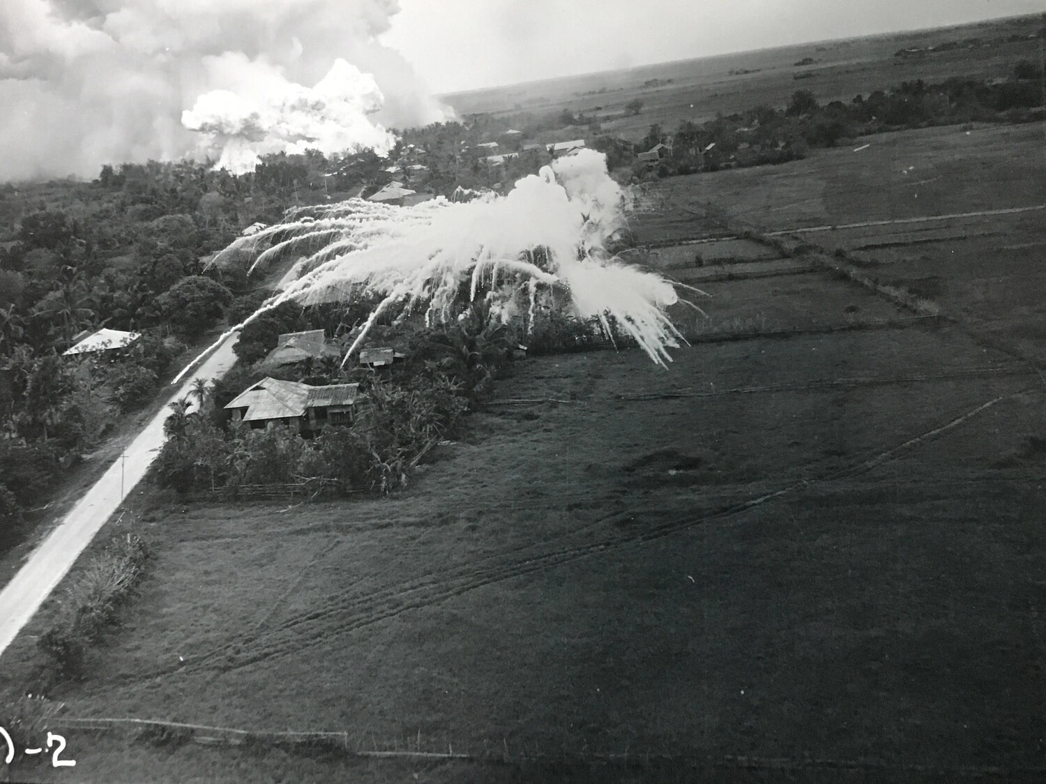 Aerial Strike Photograph of Village Attack Along Roadside, Philippines - 312th Bomb Group
