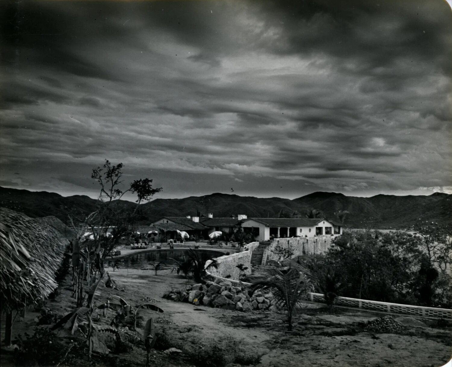Hillside Hacienda Overlooking the Sea Under Dramatic Sky, Mexico, 1949