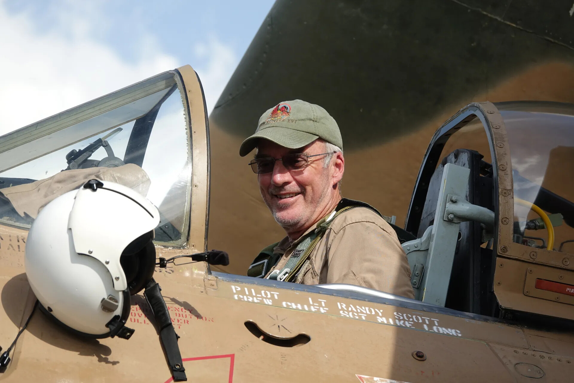 Veteran Posing in A-1 Skyraider Cockpit Marked "Pilot Lt Randy Scott, Crew Chief Sgt Mike Long," May 2019 Reunion Event