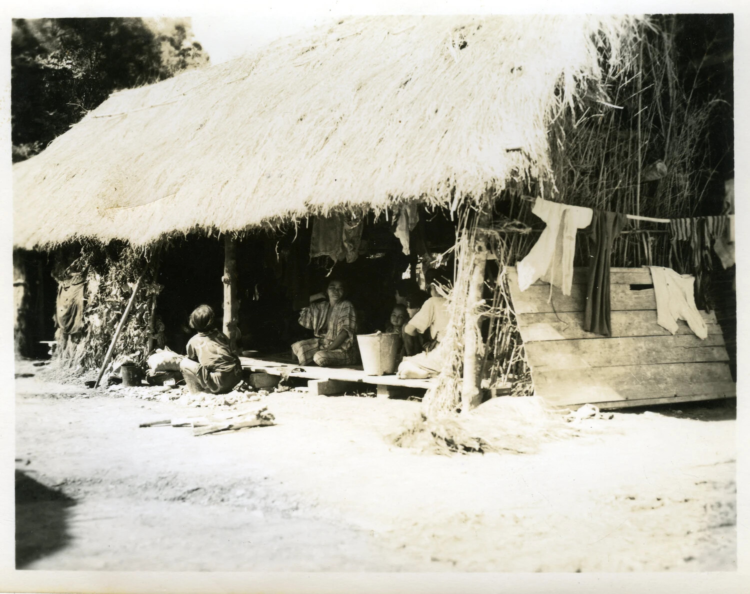 Okinawan Family at Thatched-Roof Dwelling, WWII Loose Photographs Collection