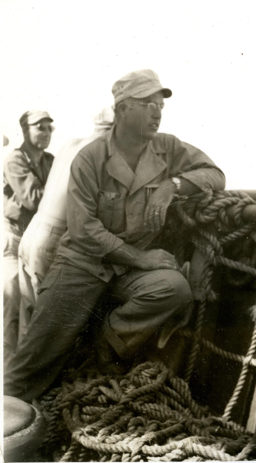 Airman Seated on Coiled Rope Aboard Troop Transport, Pacific Theater