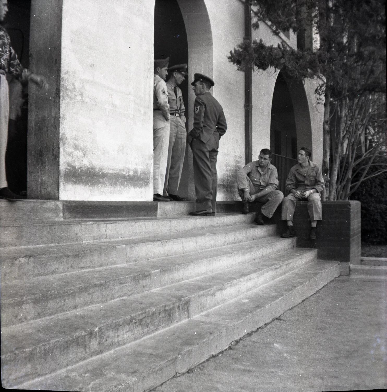 Servicemen Conversing Under Archway, USAF Base Building, 1950s