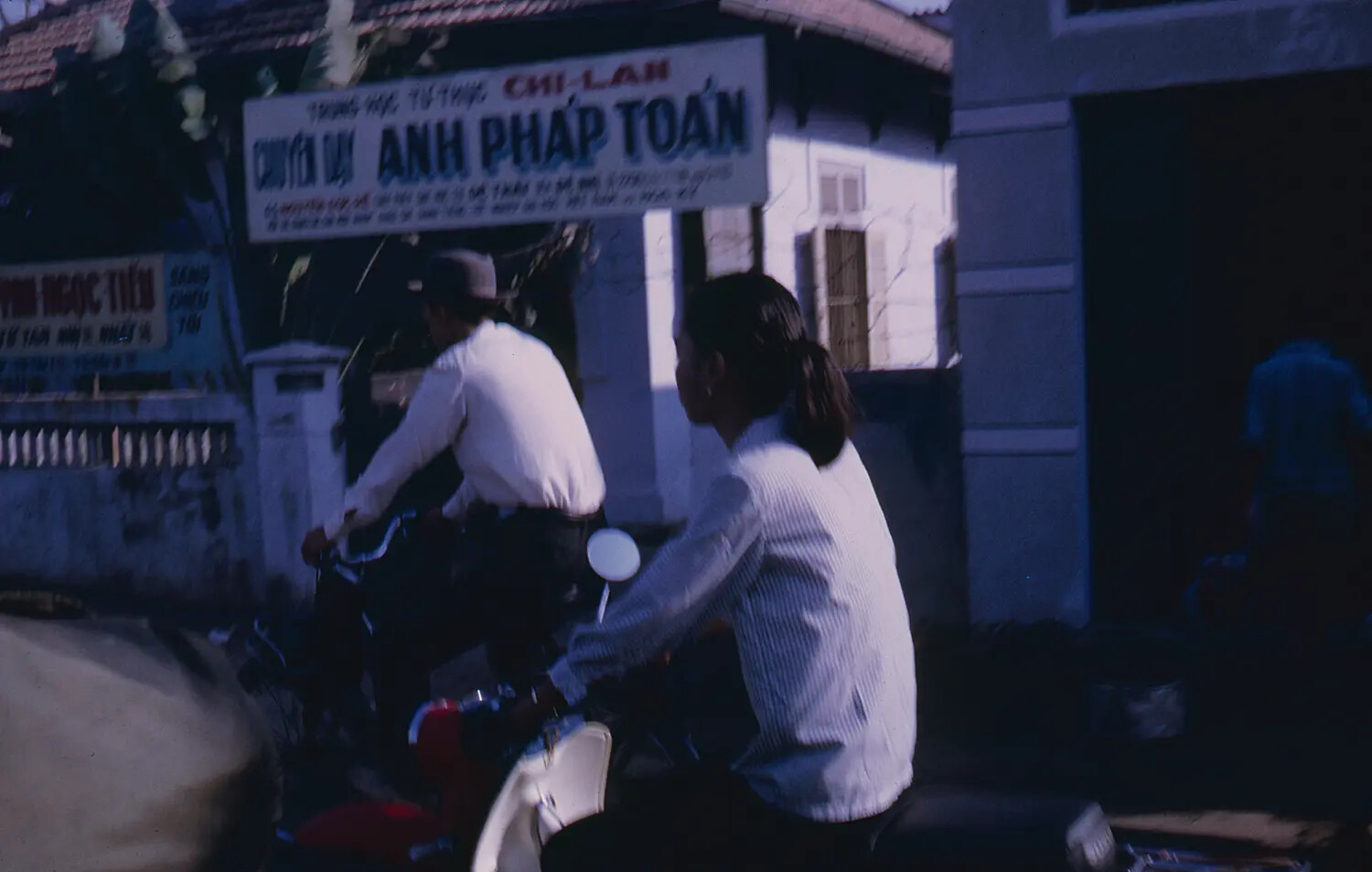 Street Scene with Moped and Bicycle Traffic Outside Chi Lan Private School, South Vietnam, 1968 Tet Period