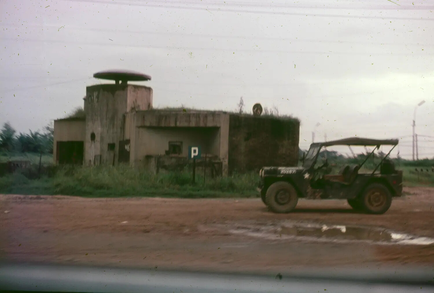 Fortified Concrete Structure and U.S. Army Jeep Along a Vietnamese Roadside, 1965