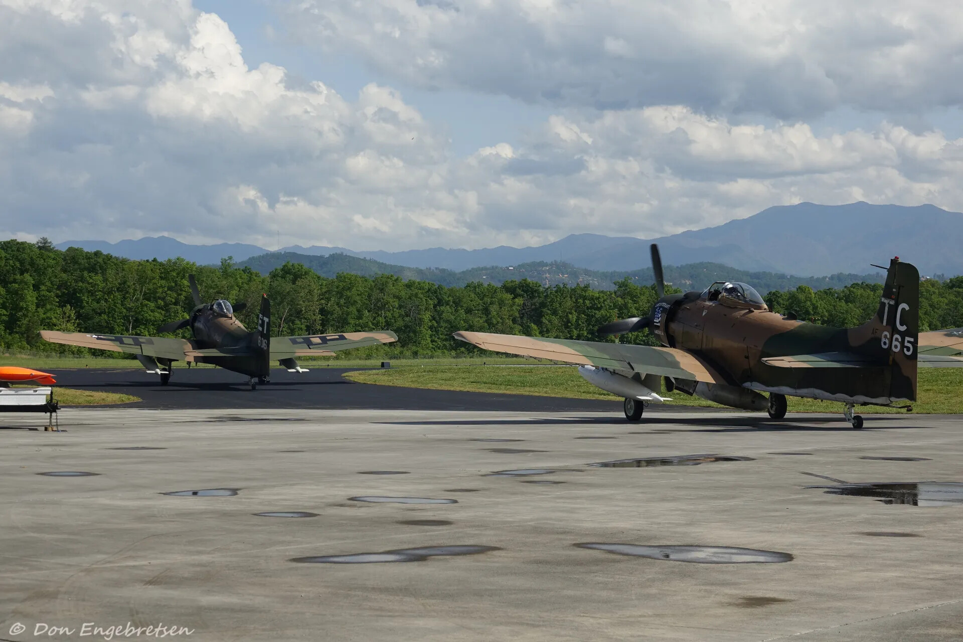Two Douglas A-1 Skyraiders 'TC-665' and 'ET-606' on Ramp Beneath Mountain Skyline, May 2019 Event (Watermarked)