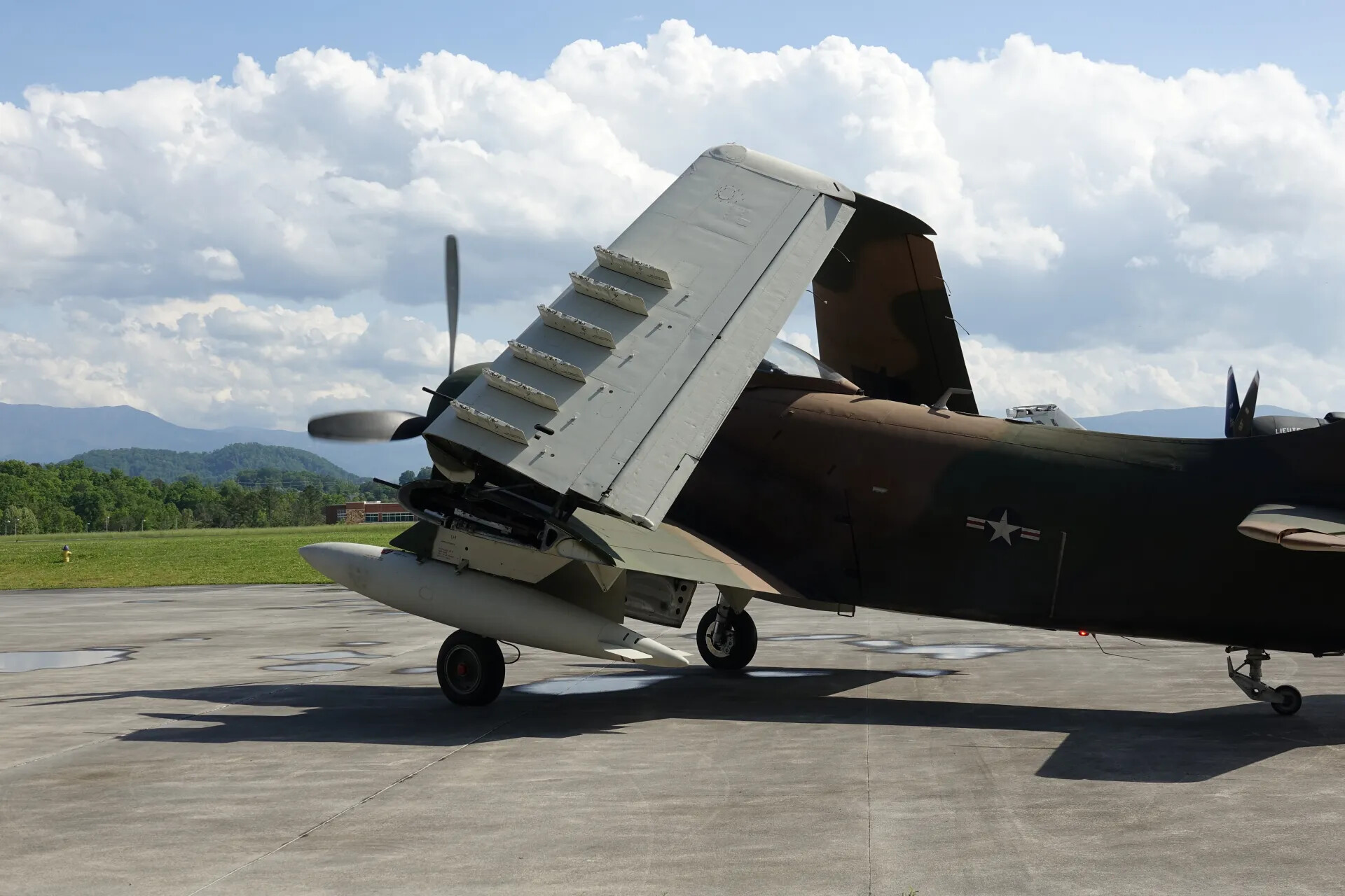 A-1 Skyraider with Folded Wing and U.S. Star Insignia on Ramp