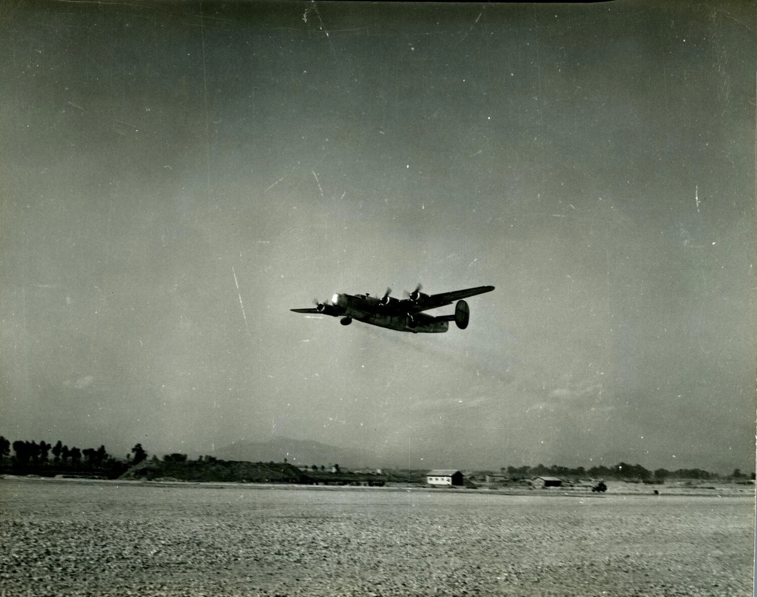 B-24 Liberator Bomber in Low Flight over Airfield, CBI Theater, WWII