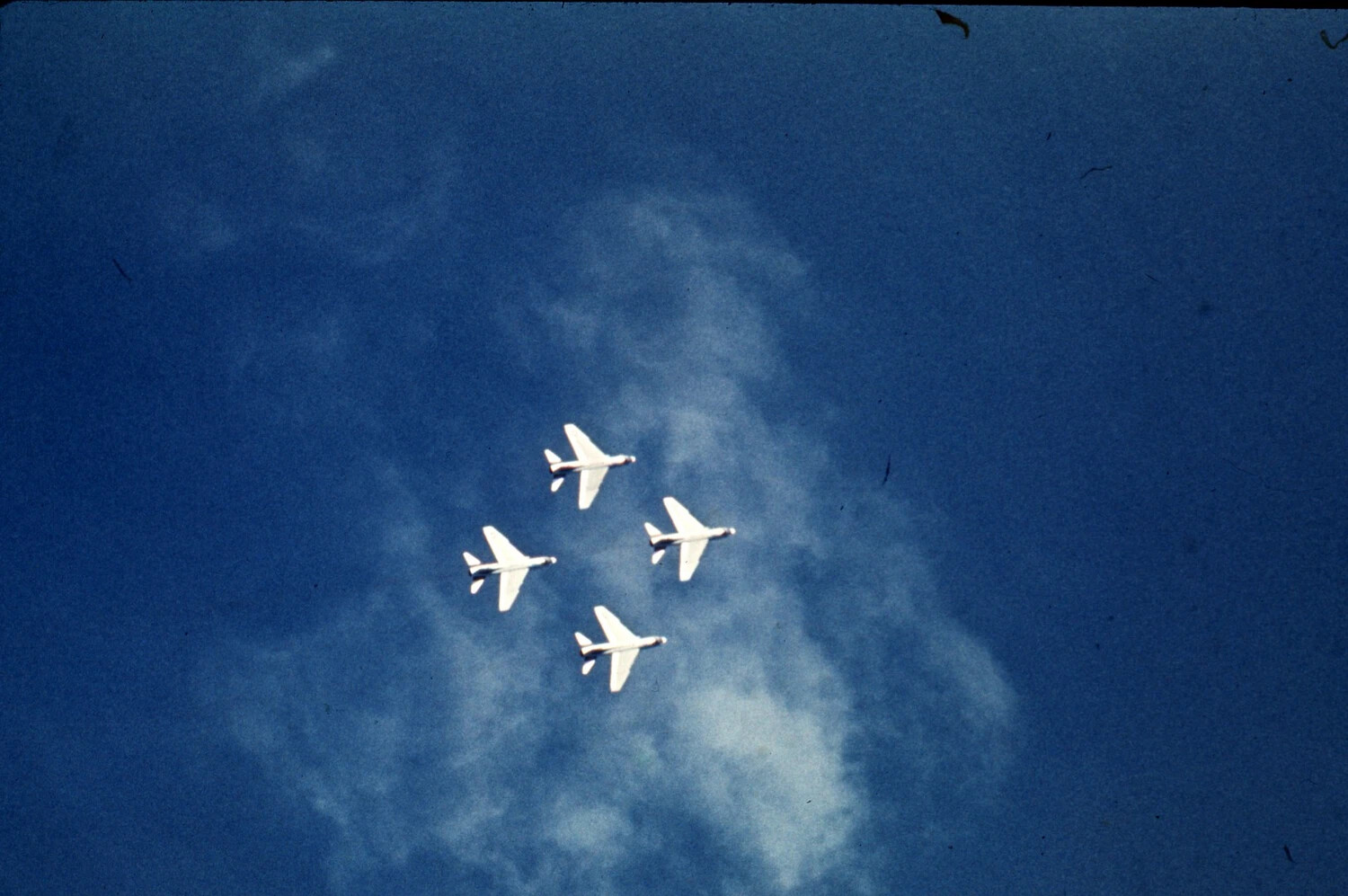 Four Jet Aircraft in Diamond Formation Flying Over Cloud Bank