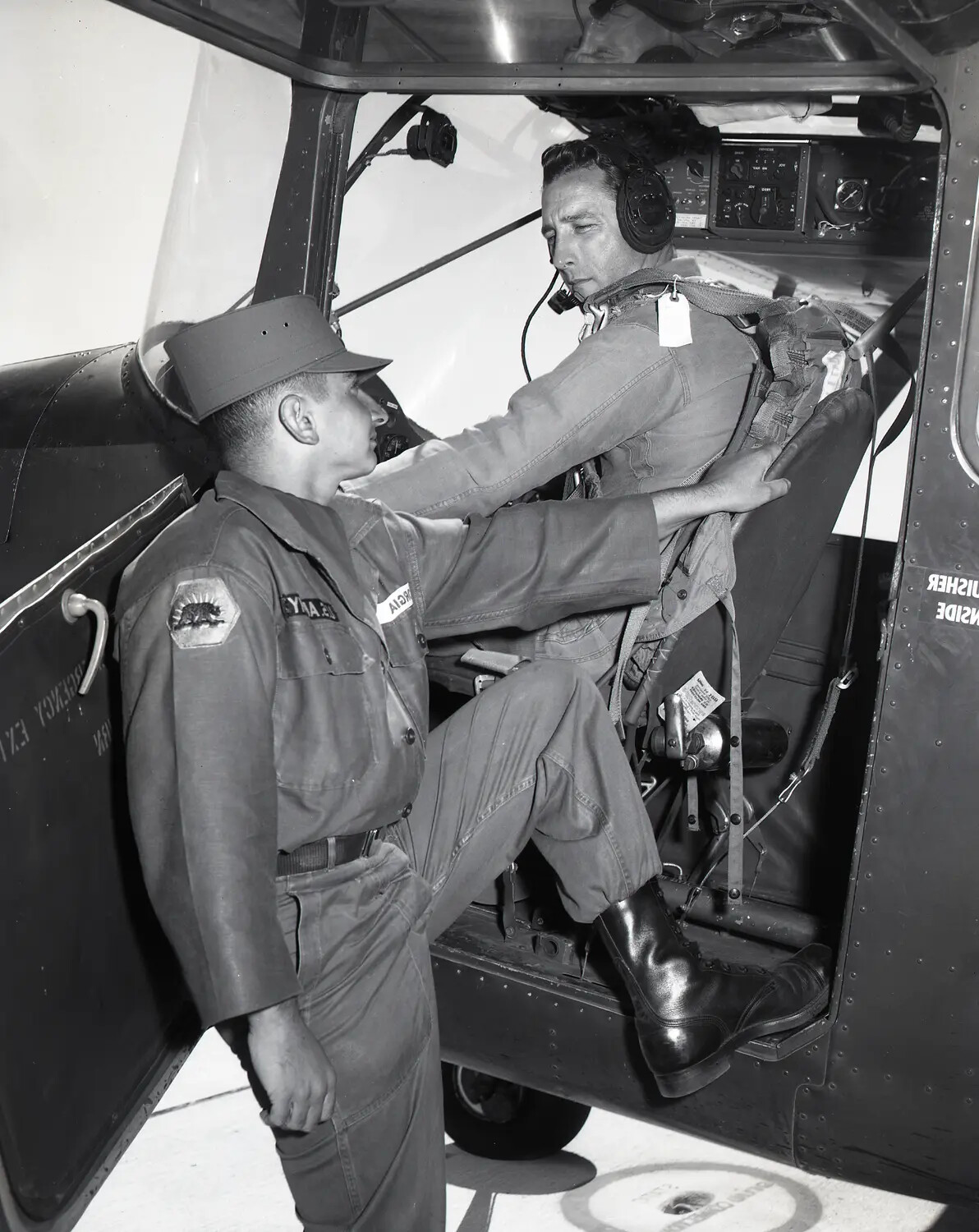 California Army National Guard Ground Crewman Assisting Pilot into Bell H-13-G Cockpit, circa 1960